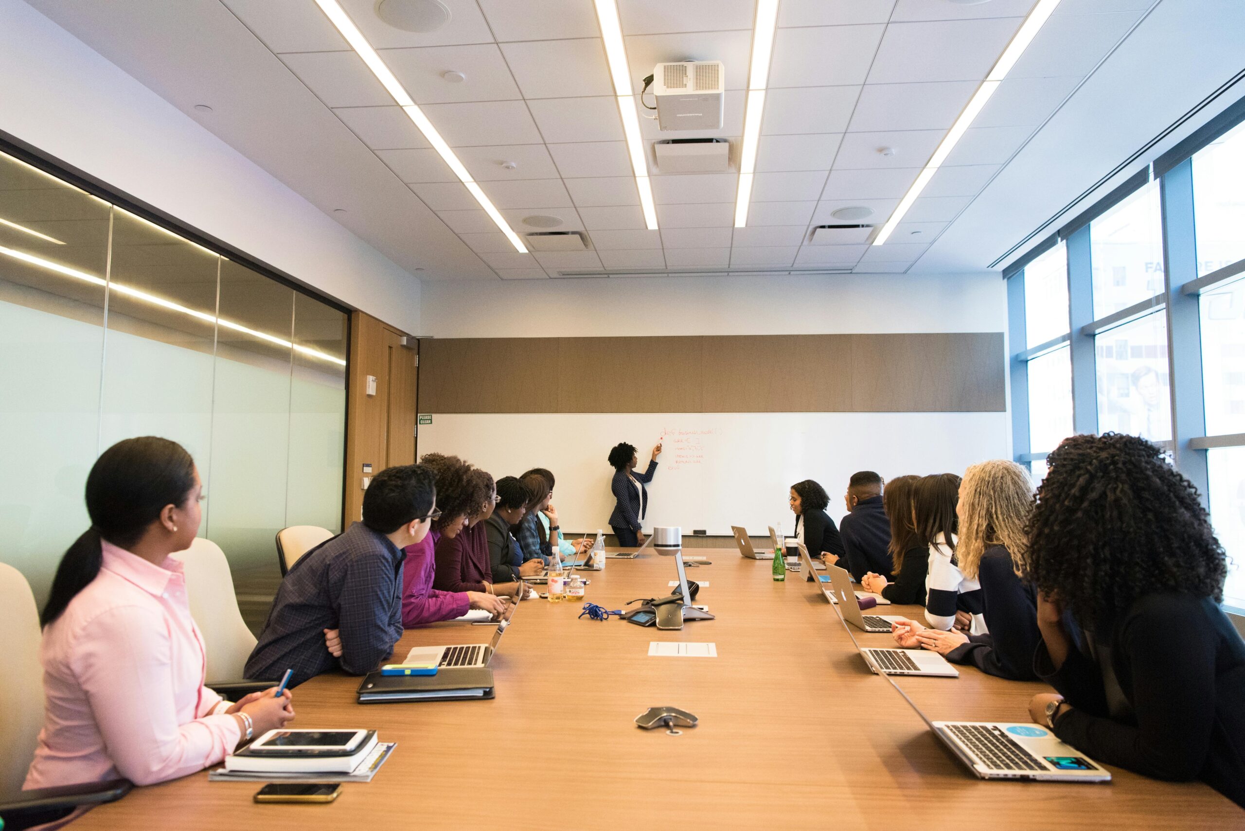 A group of sales professionals practicing communication skills in a conference room.